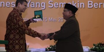 Ketua Umum DPP LDII KH Abdullah Syam kanan menyerahkan cinderamata kepada Redaktur Senior Tempo Idrus F Shahab usai pemaparan materi pada Rapimnas LDII 2014 di Balai Kartini Jakarta Kamis 1552014 Kehadirannya membahas peran strategis media dalam pembangunan bangsa Foto LINES Jatim
