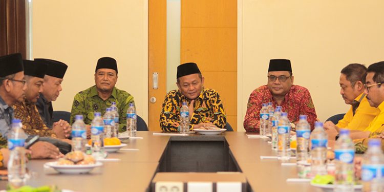 Ketua DPW LDII Jawa Timur KH Moch Amrodji Konawi (kanan) menyambut kedatangan Ketua DPD Golkar Jawa Timu M Sarmuji (tengah) beserta jajaran, Jumat (12/5). Dok: LINES.