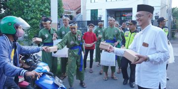 Ketua PC LDII Kecamatan Gunung Anyar Giyato kanan bagikan takjil pada pengendara di kawasan jalan raya Ir Soekarno MERR Surabaya Minggu 243 Dok LINES