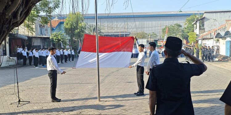 Peserta upacara memberikan penghormatan saat bendera Merah Putih dikibarkan oleh santri Al-Huda Tundungan pada peringatan HUT ke-80 RI, di halaman Masjid Al-Huda, Krian, Sidoarjo. Dok: LINES.