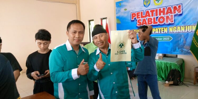 Ketua DPD LDII Kabupaten Nganjuk, Murkani (kanan), menunjukkan hasil karya peserta Pelatihan Sablon yang digelar di Aula DPD LDII Nganjuk, Minggu (19/10/2025). Kegiatan ini membekali generasi muda LDII dengan keterampilan wirausaha guna mendorong kemandirian ekonomi. (Dok. LINES Nganjuk)