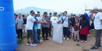 Wakil Ketua Komisi D DPRD Jawa Timur, didampingi jajaran Forkopimka Tarokan, mengibarkan bendera start sebagai tanda dimulainya Jalan Sehat OSAKA 2025 di Lapangan Pojok, Desa Bulusari, Kecamatan Tarokan, Kediri, Minggu (30/11). Kegiatan yang diselenggarakan LDII Kediri itu diikuti ribuan peserta dari berbagai kecamatan, termasuk masyarakat umum serta para santri dari pondok pesantren. Foto: Dok. LINES Kediri.