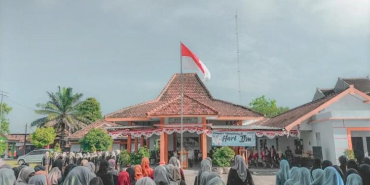 Sejumlah santriwati Pondok Pesantren (Ponpes) Millenium Alfiena turut mengikuti upacara peringatan Hari Ibu ke-97 di halaman Kantor Kecamatan Lengkong, Kabupaten Nganjuk, Selasa (22/12/2025). Dok: LINES.
