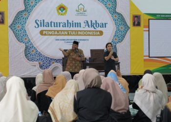 Sekretaris DPW LDII Jawa Timur, Bambang Raditya Purnomo, menyampaikan sambutan dan ucapan selamat datang dengan didampingi juru bahasa isyarat pada kegiatan Silaturahim Akbar Pengajian Tuli Indonesia di GSG Sabilurrosyidin, Surabaya, yang diikuti puluhan generasi tuli dari berbagai daerah, Jumat (2/1). Foto: Dok. LINES Jatim